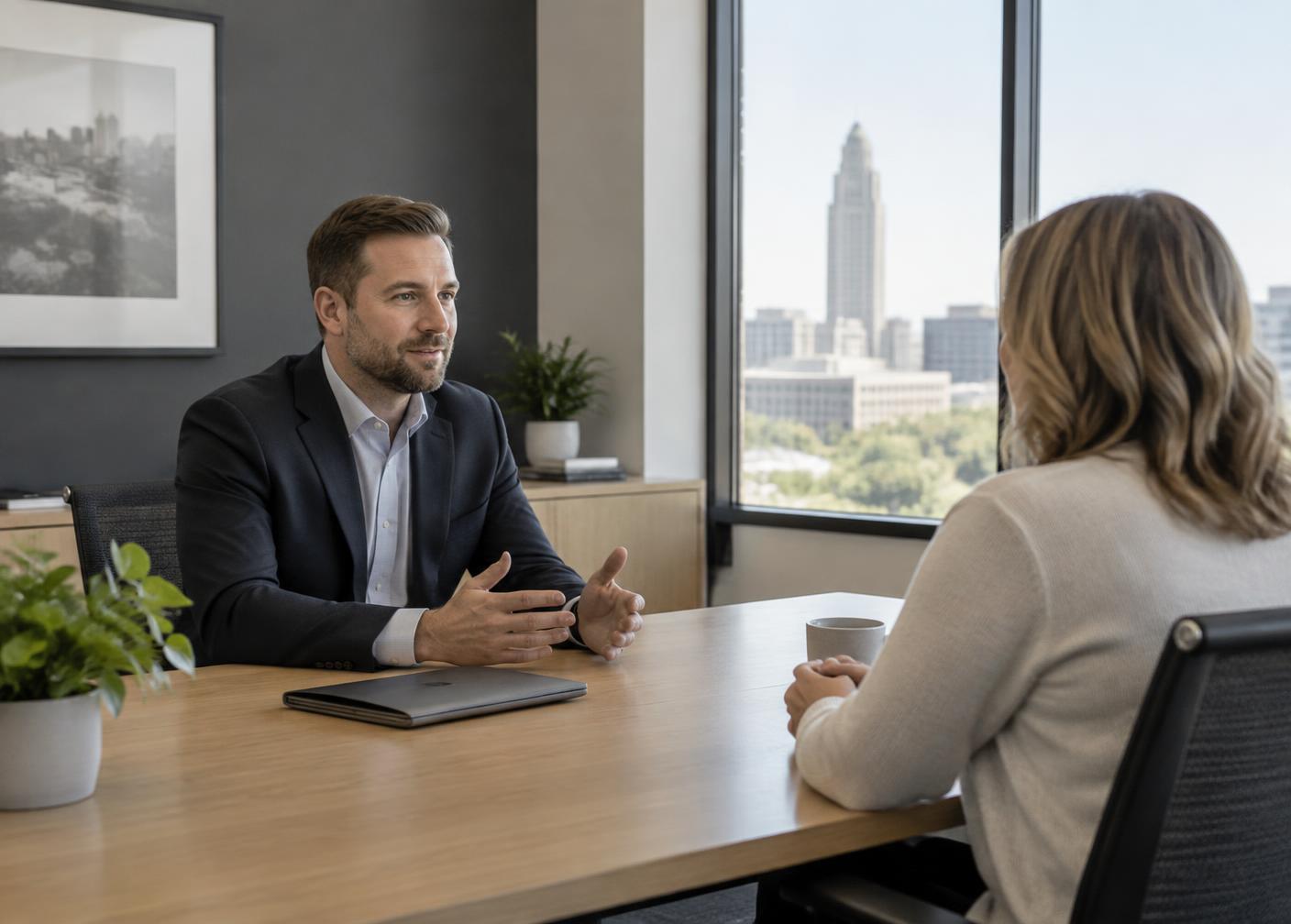 A planner and a client talking across a table in a Lincoln office